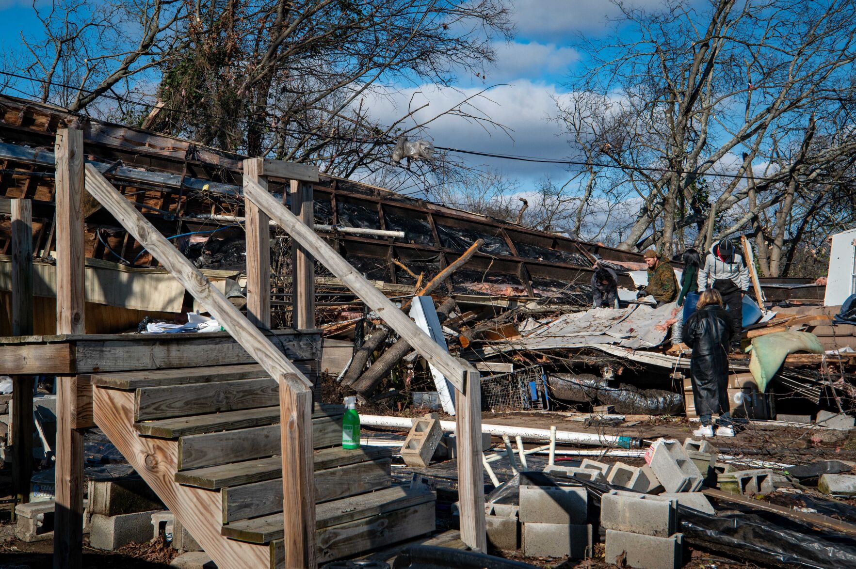 Utility poles, power lines and debris scattered across Madison's Nesbitt Lane on Dec. 10